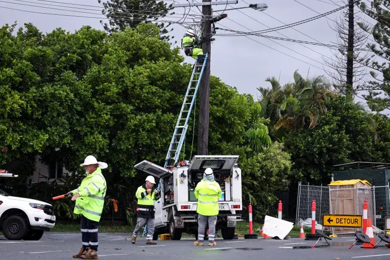 Emergency response team repairing power lines after Cyclone Alfred in 2025